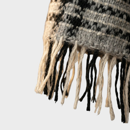 Tasoni oversized mohair and wool check scarf in grey, black, and cream with fringed edges.
