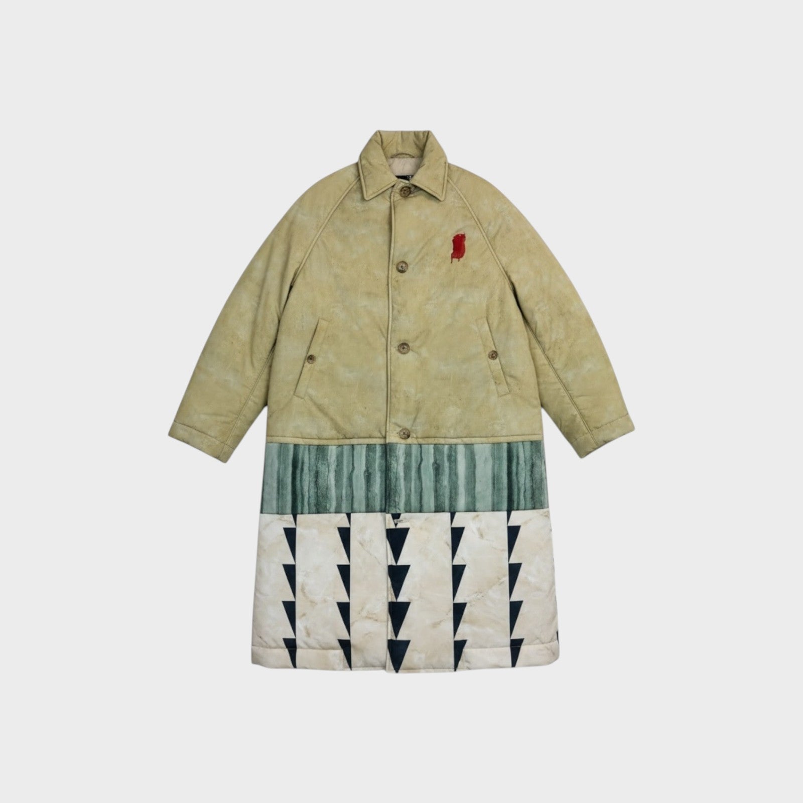 Tasoni beige oversized padded coat with a red embroidered detail on the chest and a multi-panelled lower half featuring abstract green stripes and a marble-effect print with black triangles.