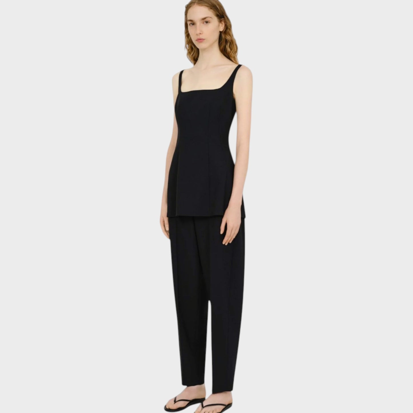 Model wearing a black Tasoni Partow Callen twill top with a square neckline and matching trousers.
