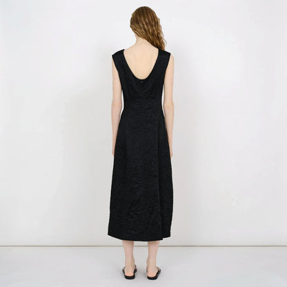 Model wearing a black Tasoni Partow Koda cotton blend midi dress with a scoop back and textured fabric finish.