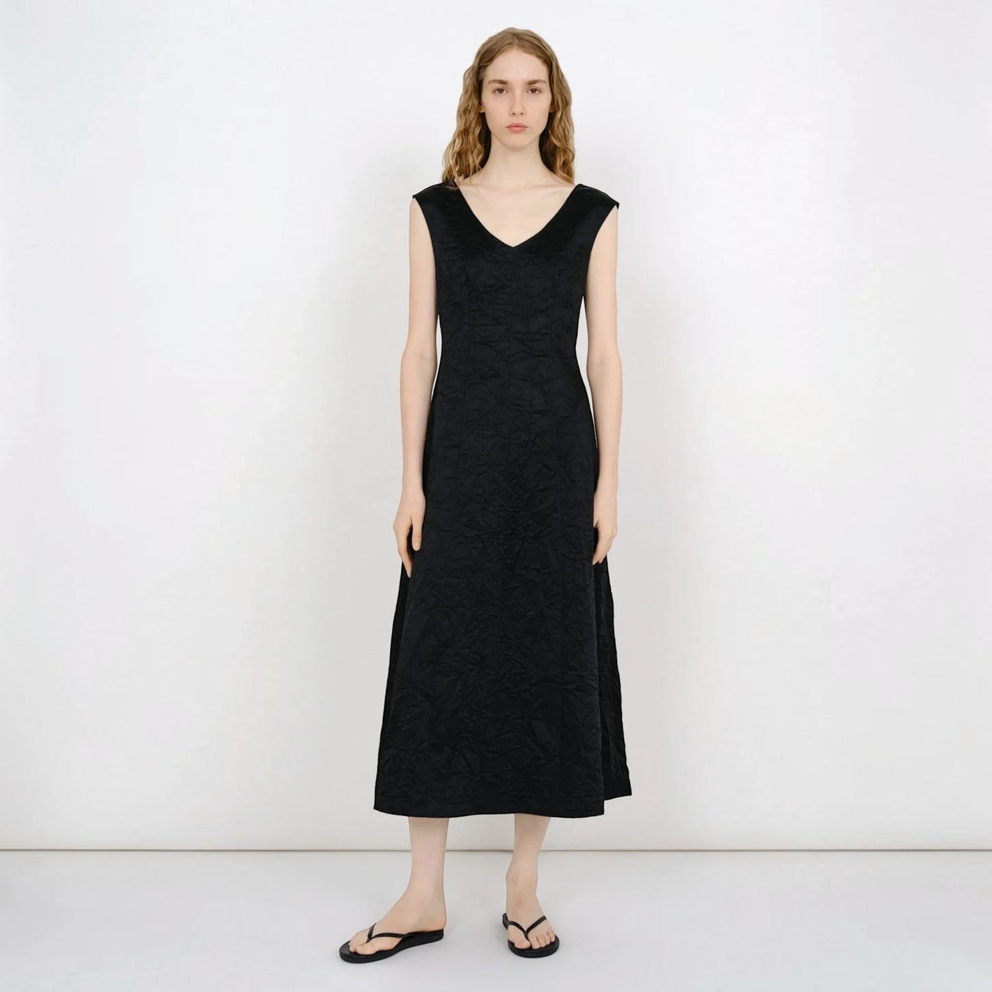 Model wearing a black Tasoni Partow Koda cotton blend midi dress with a V-neck and textured fabric finish.