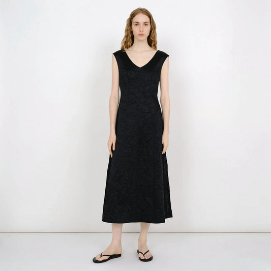 Model wearing a black Tasoni Partow Koda cotton blend midi dress with a V-neck and textured fabric finish.