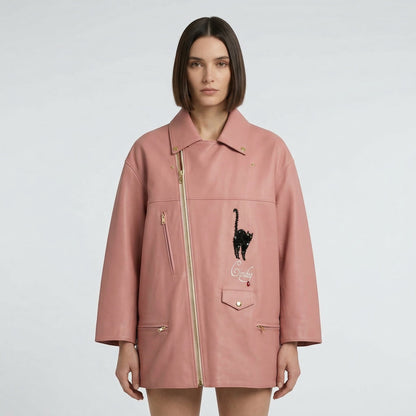 Tasoni pink leather biker coat with black cat appliqué and yellow lining. Features gold zippers and a unique asymmetrical closure.