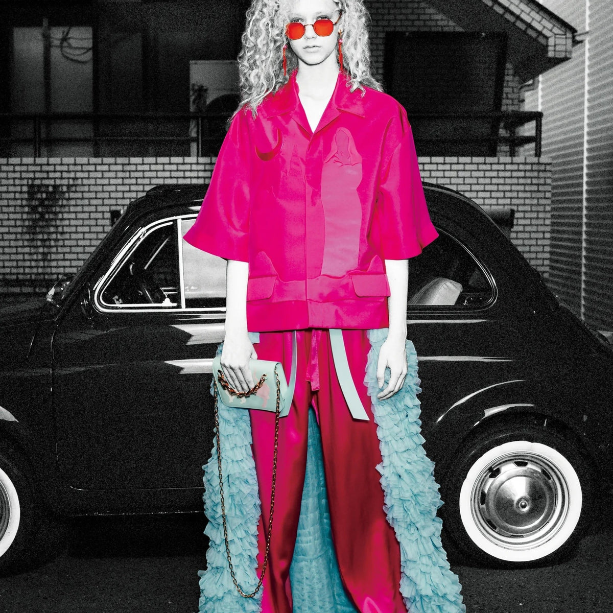 Tasoni pink short sleeve shirt with woman and moon motif, paired with pink satin pants and a blue ruffled overlay.