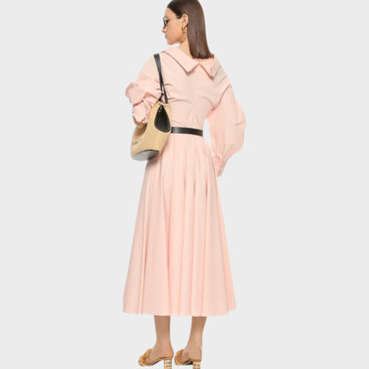 Tasoni pink silk poplin circular long skirt with a wide collar and puffed sleeves, cinched with a black belt.