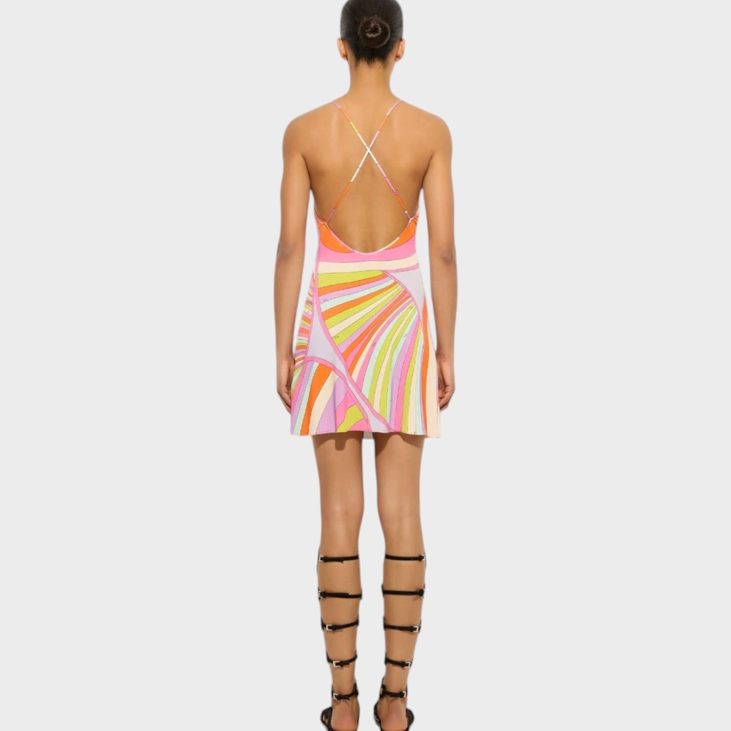 Tasoni Pucci multicolor mini dress with Iride print, deep back, and crisscross straps worn by a model.