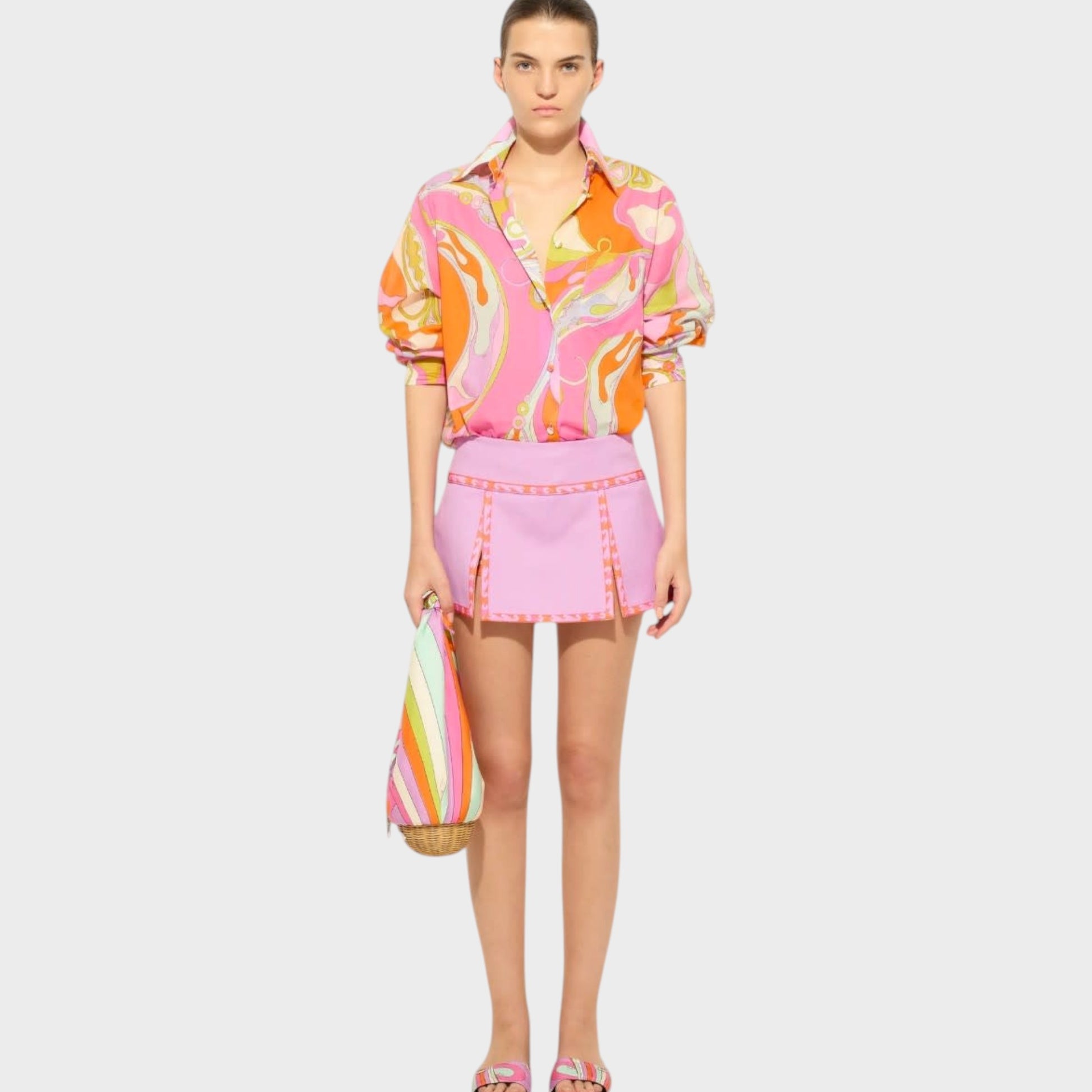 Model wearing a Tasoni Pucci multicolor cotton classic shirt with Orchidee print and a pink mini skirt.