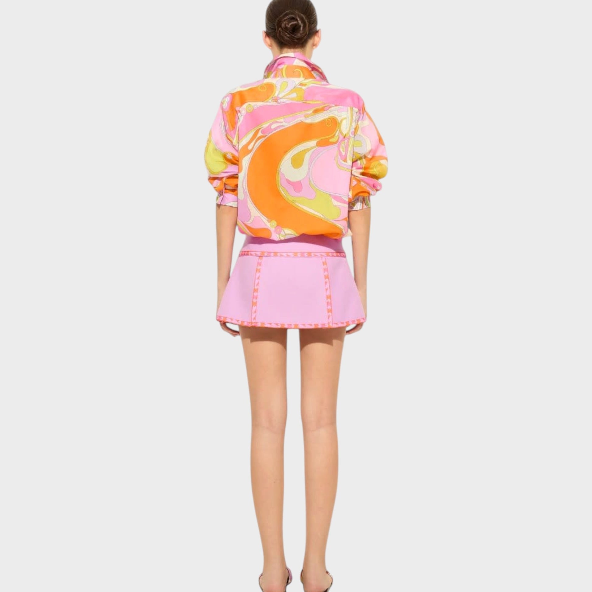 Tasoni Pucci cotton classic shirt featuring a vibrant multicolor Orchidee print, worn with a matching pink mini skirt.