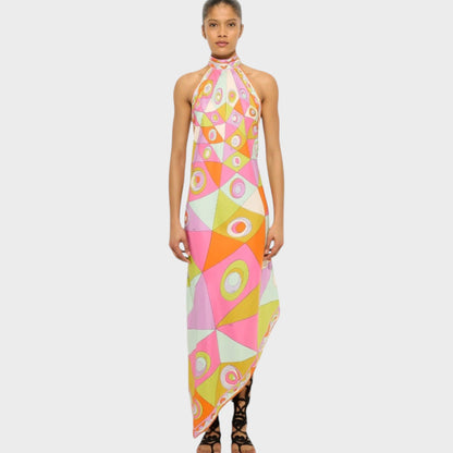 Model wearing a Tasoni Pucci silk halter neck dress with a colorful geometric print and an asymmetrical hemline.