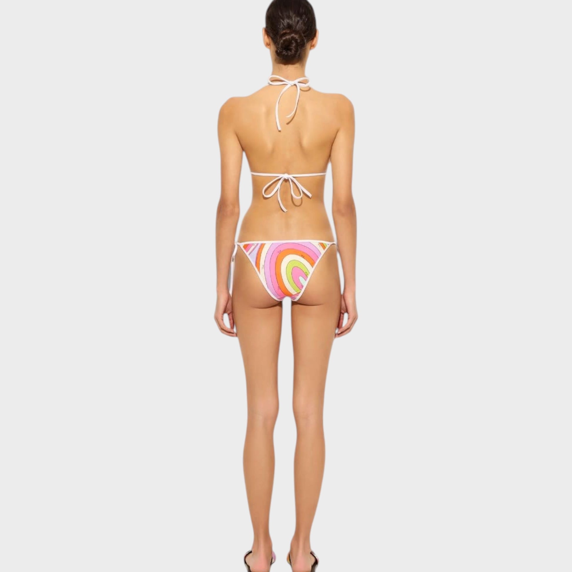 Model wearing a Tasoni Pucci triangle bikini top with a colorful swirl print and white tie-back straps.