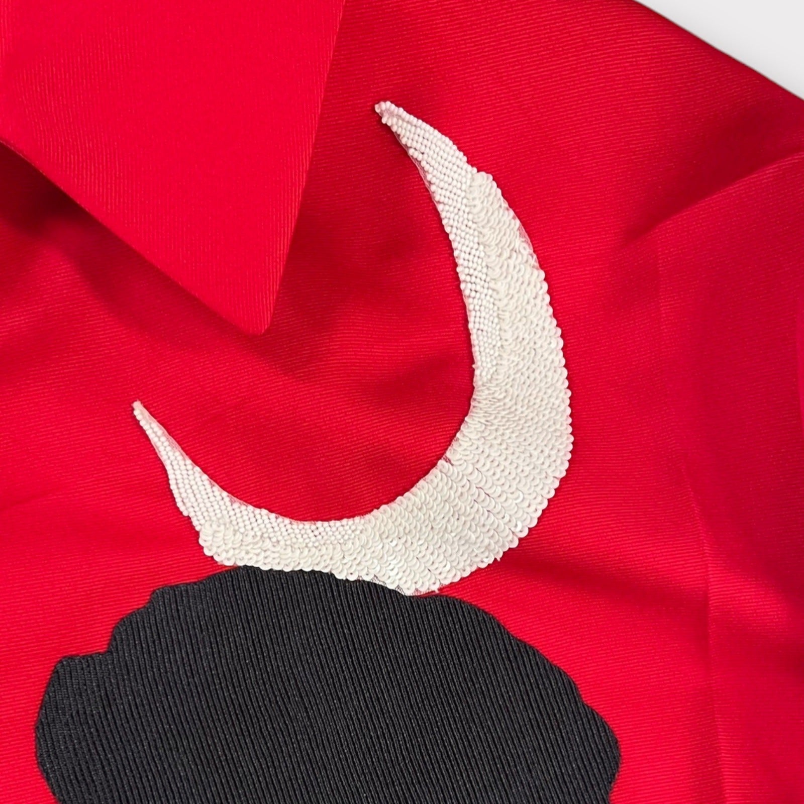 Tasoni red jacket with classic collar, featuring a white sequined crescent moon and black embroidered motive.