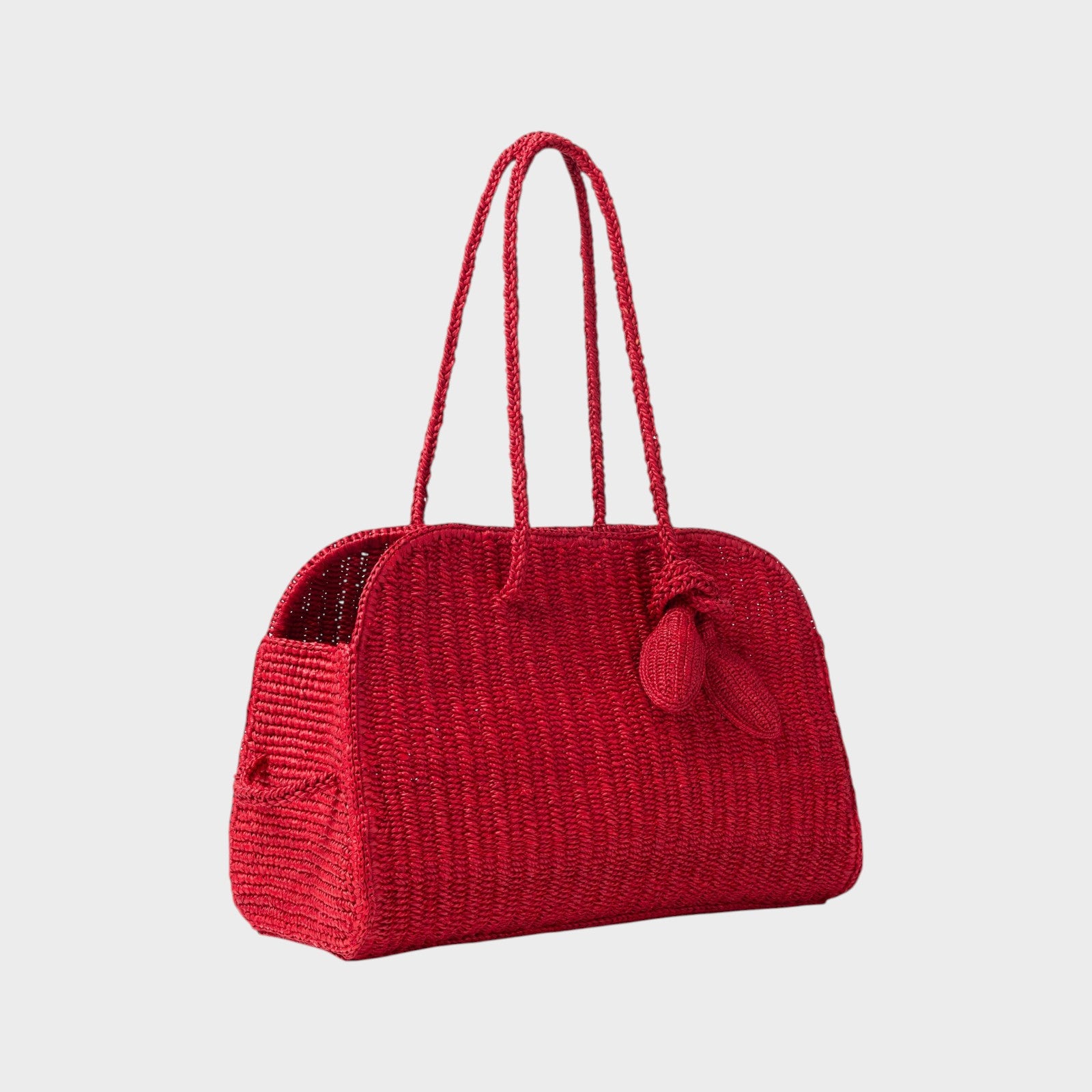 Tasoni red raffia tote bag with braided handles and a decorative tassel.