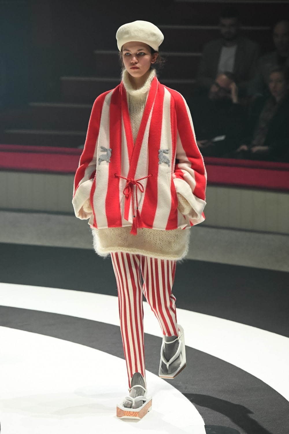 Tasoni red and white striped wool and cashmere coat with rabbit sequin embroidery, worn by a model on a runway.