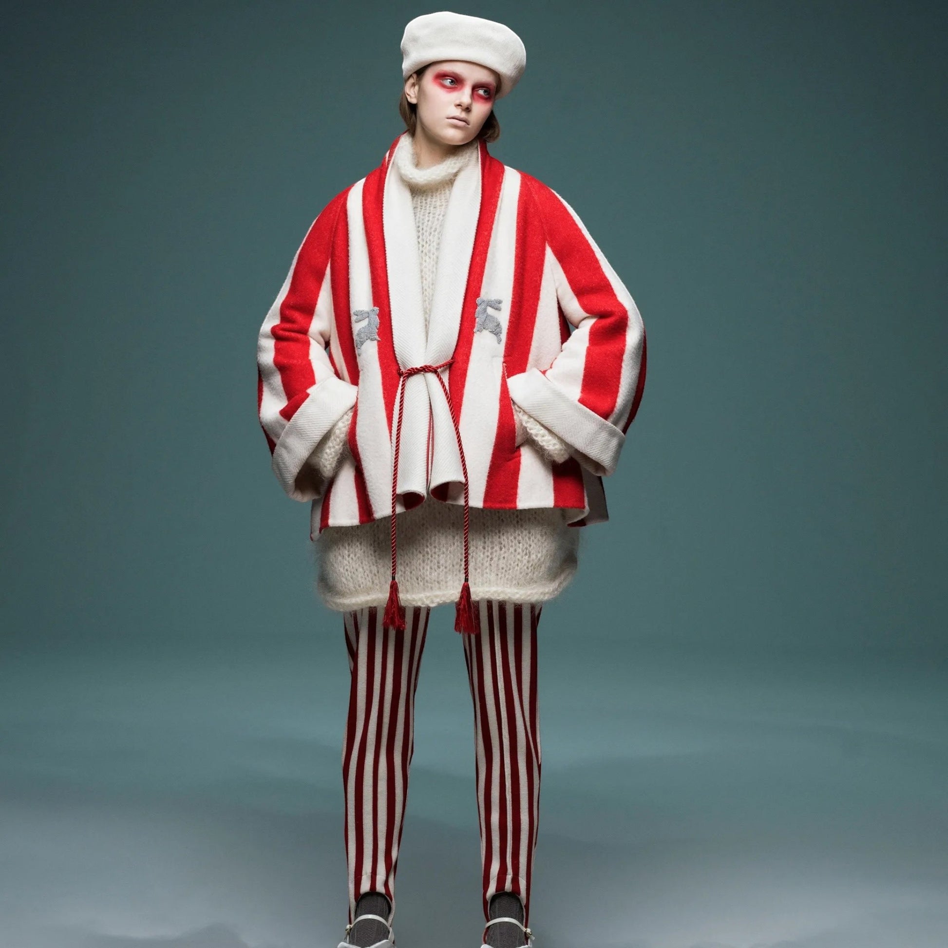Tasoni red and white striped wool trousers with elastic waist and tassel tie. Model wears a matching jacket and knitwear.