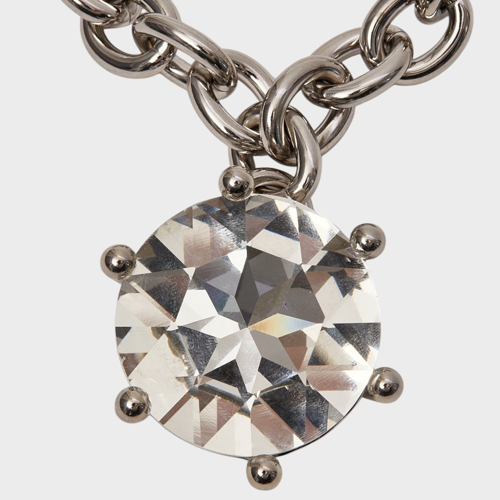 Tasoni Marie Adam-Leenaerdt necklace with a large clear crystal pendant and silver chain. Brass setting.
