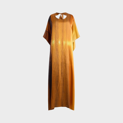 Tasoni Marie Adam-Leenaerdt sunset landscape print silk satin dress in sunset light orange with tie-back detail.