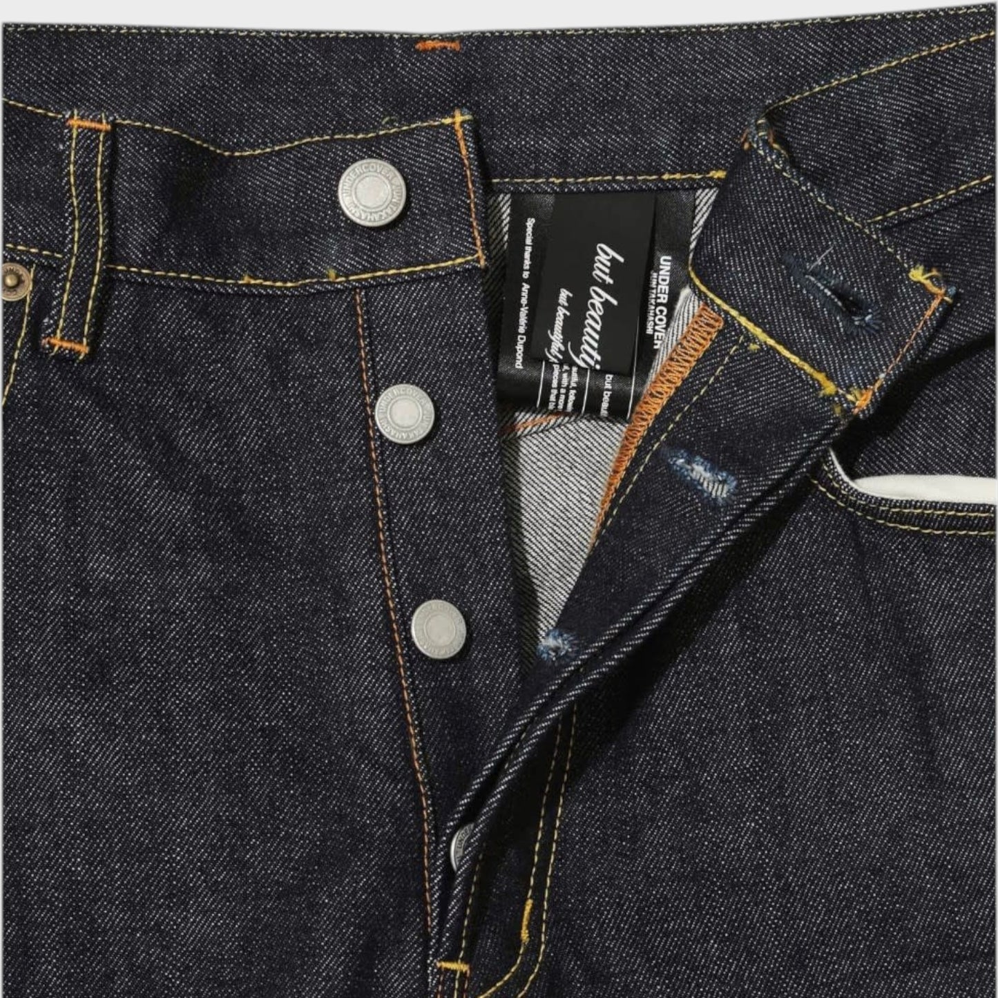 Tasoni x Undercover blue denim wide leg pants with embroidered poem detail and button fly.