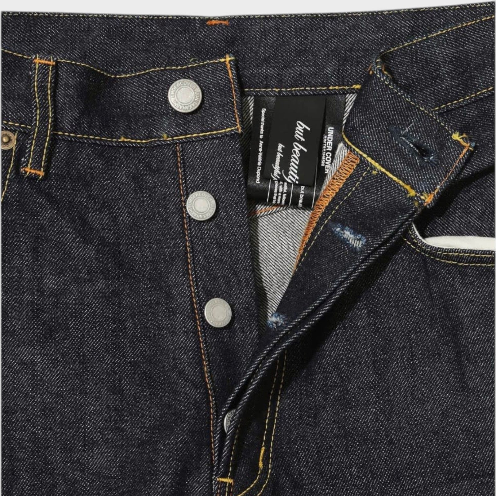 Tasoni x Undercover blue denim wide leg pants with embroidered poem detail and button fly.