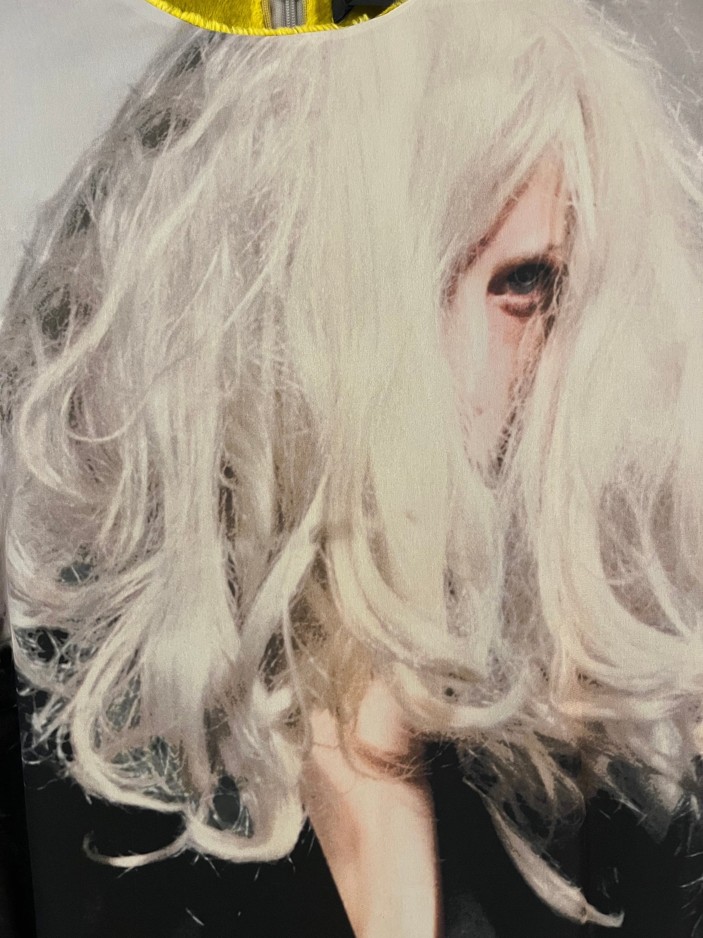 Tasoni Undercover Dress featuring a striking print of a woman with messy blonde hair partially obscuring her face, yellow lining, and zipper detail.