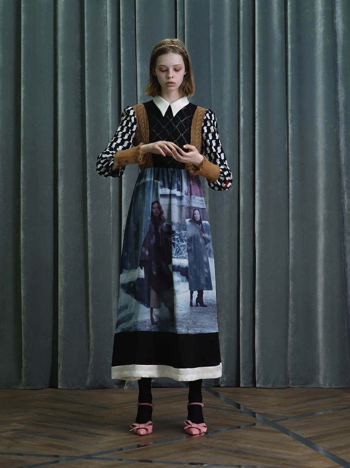 Tasoni Undercover Dress features a white collar, black diamond knit bodice, and long sleeves with a black and white checkered pattern. The skirt has a striking print of two figures in a wintery scene.
