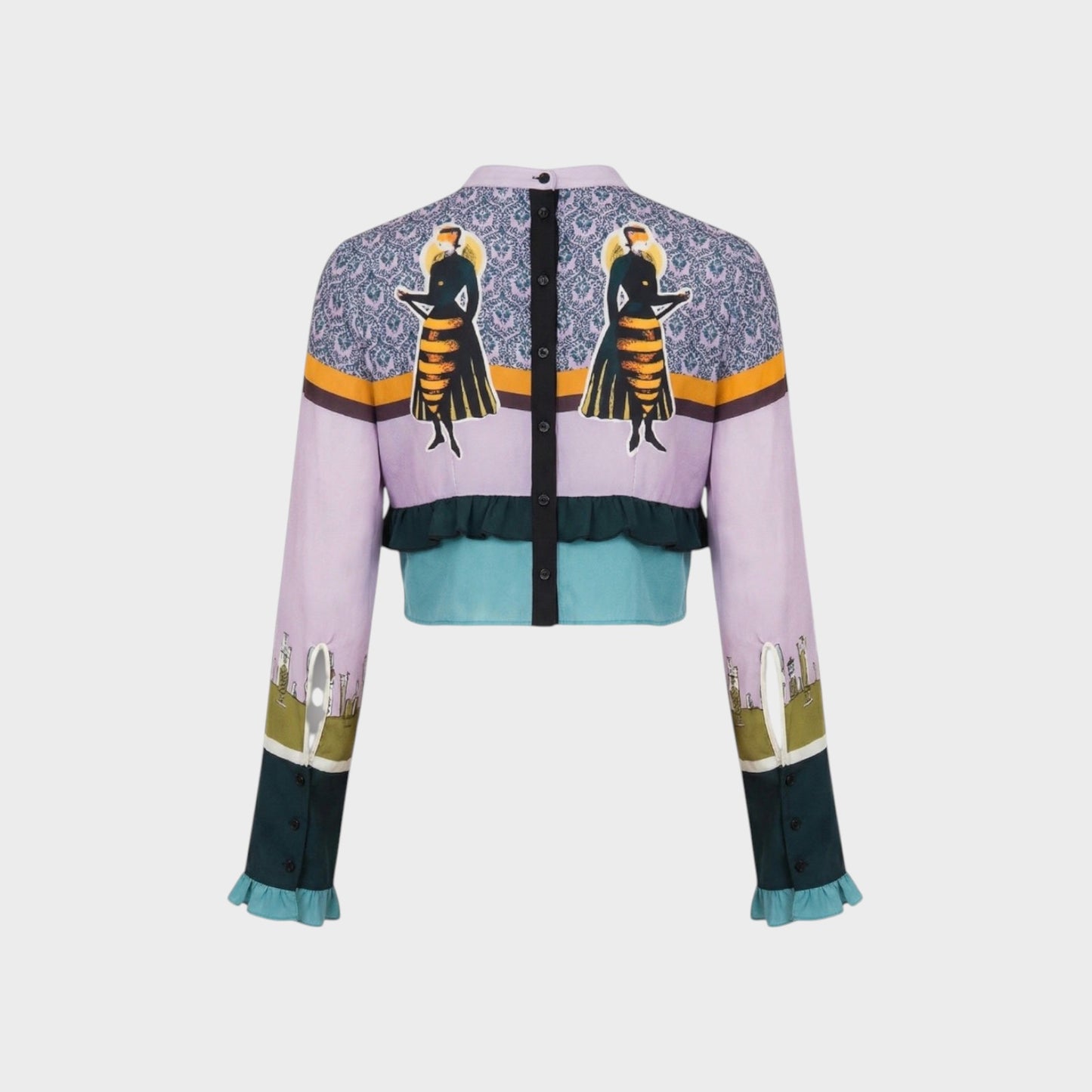 Tasoni Undercover Silk Top, a cropped jacket with a lilac base, featuring a patterned yoke with two figures, ruffled teal hem, and printed sleeves.