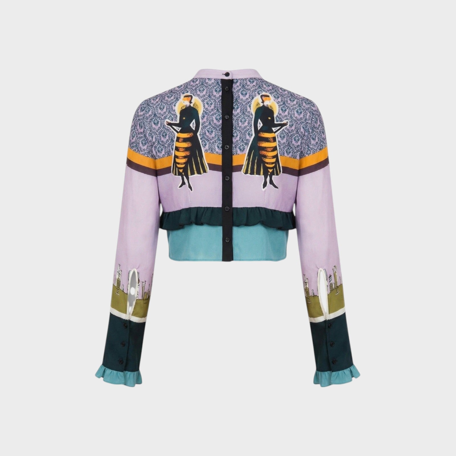 Tasoni Undercover Silk Top, a cropped jacket with a lilac base, featuring a patterned yoke with two figures, ruffled teal hem, and printed sleeves.