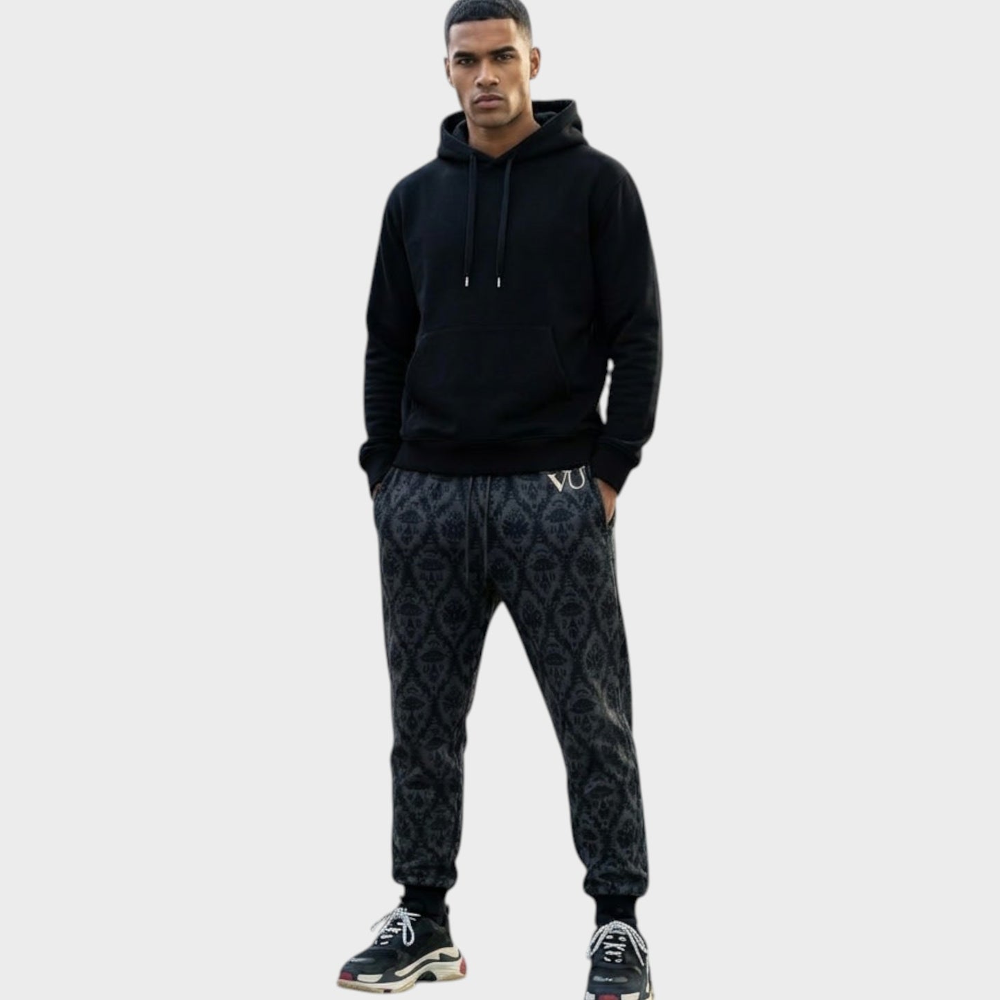 Tasoni Undercover x VLTN black and grey patterned cotton drawstring sweatpants worn by a male model.