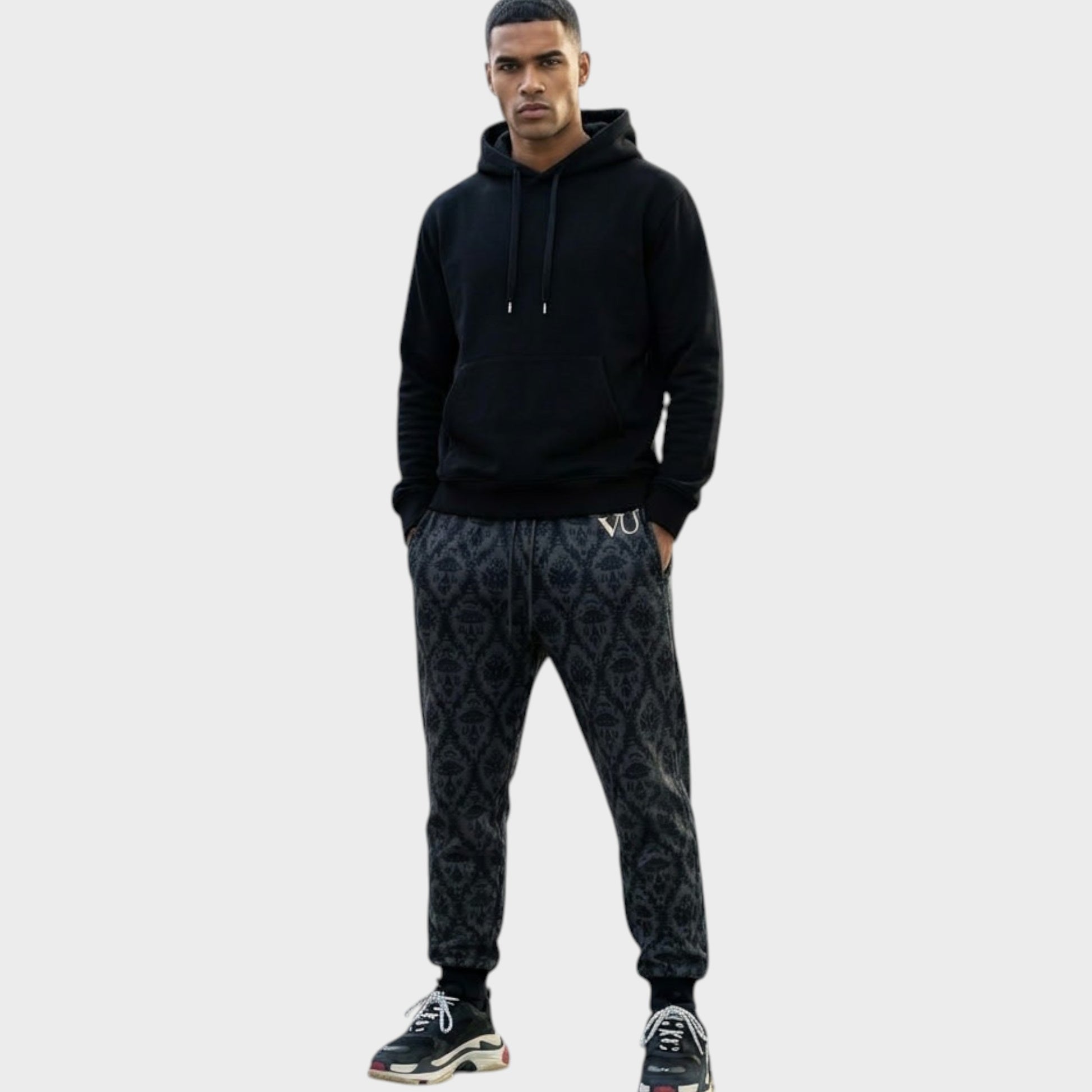 Tasoni Undercover x VLTN black and grey patterned cotton drawstring sweatpants worn by a male model.