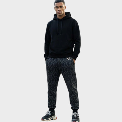 Tasoni Undercover x VLTN black and grey patterned cotton drawstring sweatpants worn by a male model.