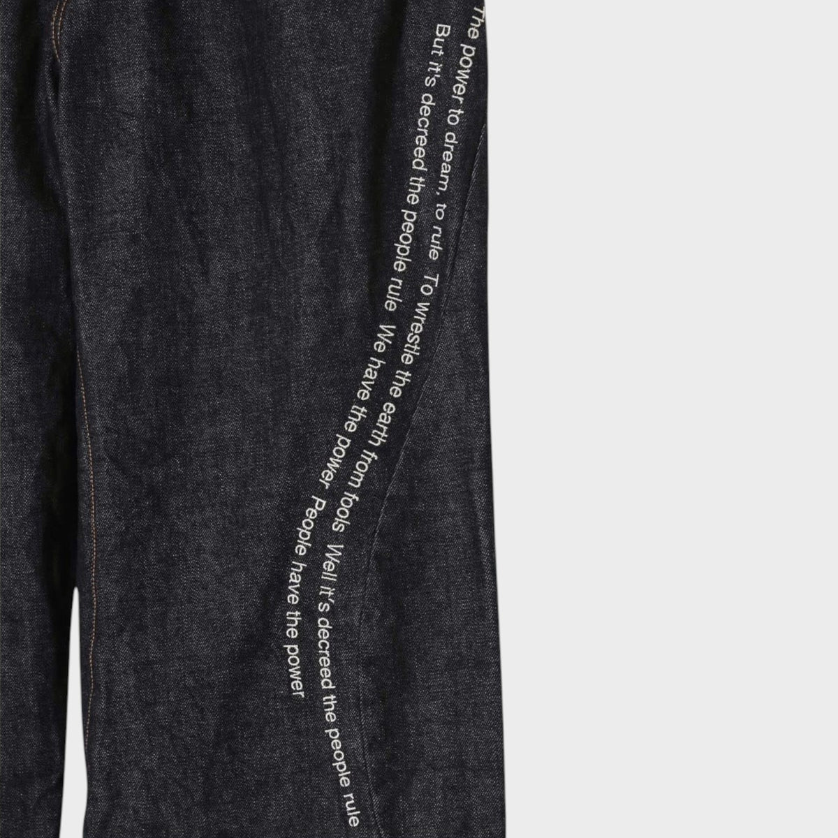 Tasoni x Undercover Patti Smith wide leg indigo denim pants with embroidered poem detail.
