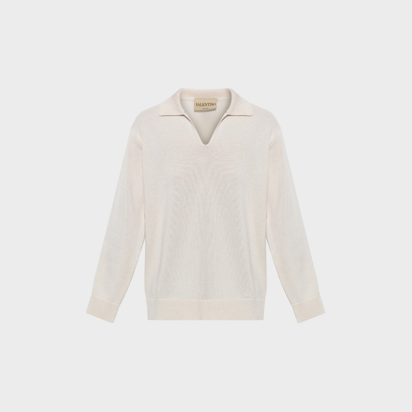 Tasoni Valentino cream cashmere V-neck polo sweater with long sleeves and ribbed cuffs and hem.