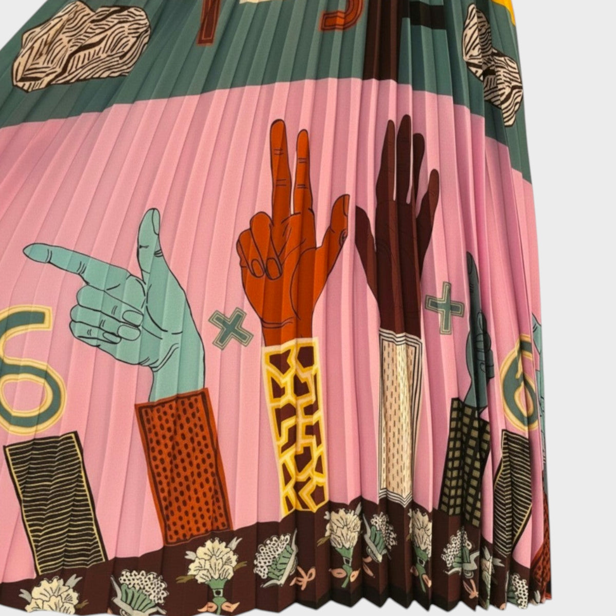 Tasoni Valentino crepe de chine pleated skirt featuring a vibrant pink background with graphic hand illustrations.