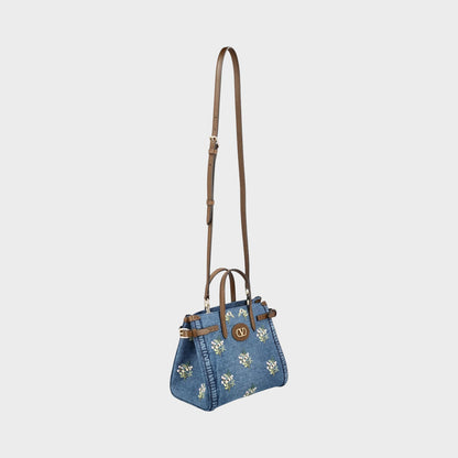 Tasoni Valentino small denim tote bag with multicolor flower bouquet embroidery and brown leather trim.