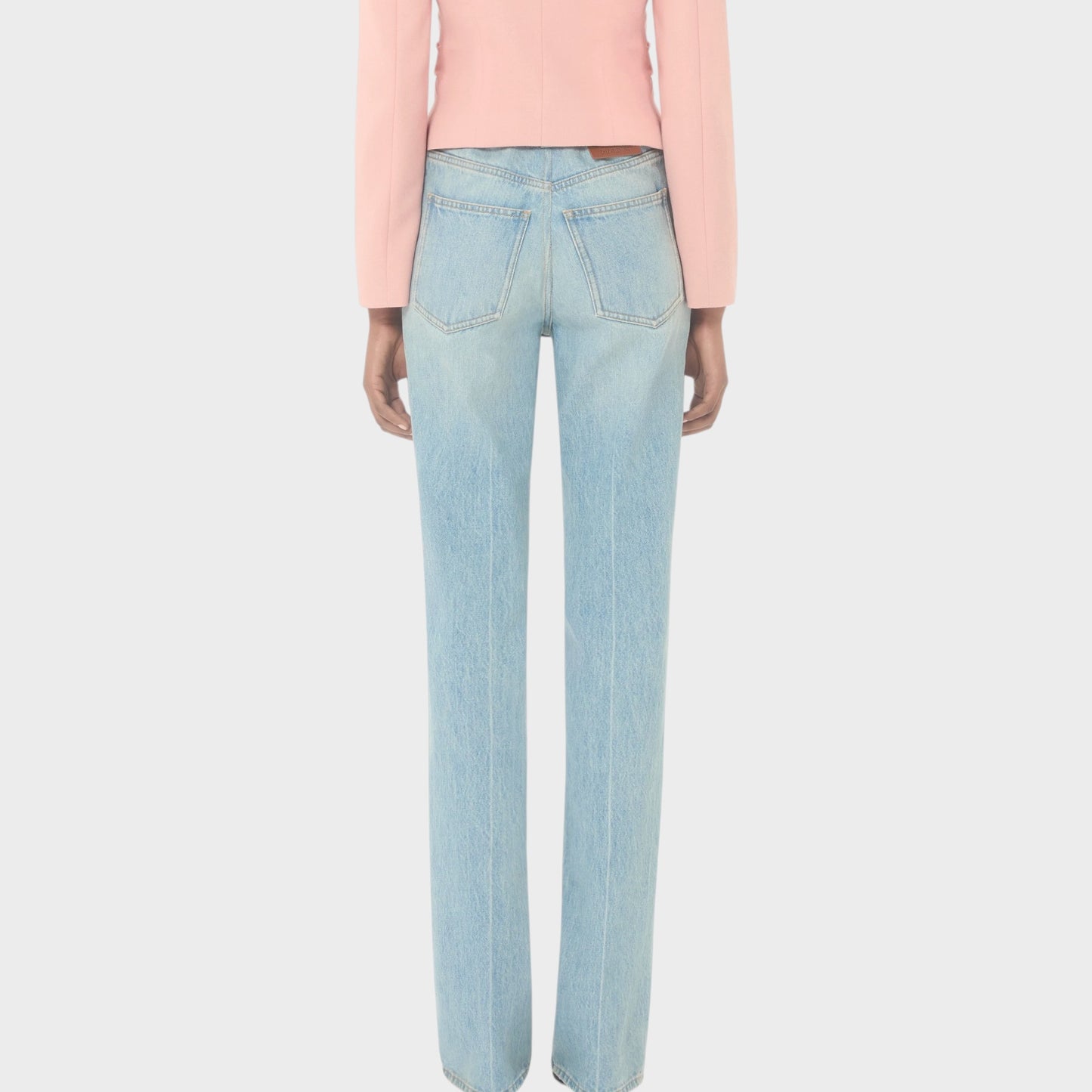 Tasoni Valentino high-waisted straight leg light wash denim jeans with a pink blazer.