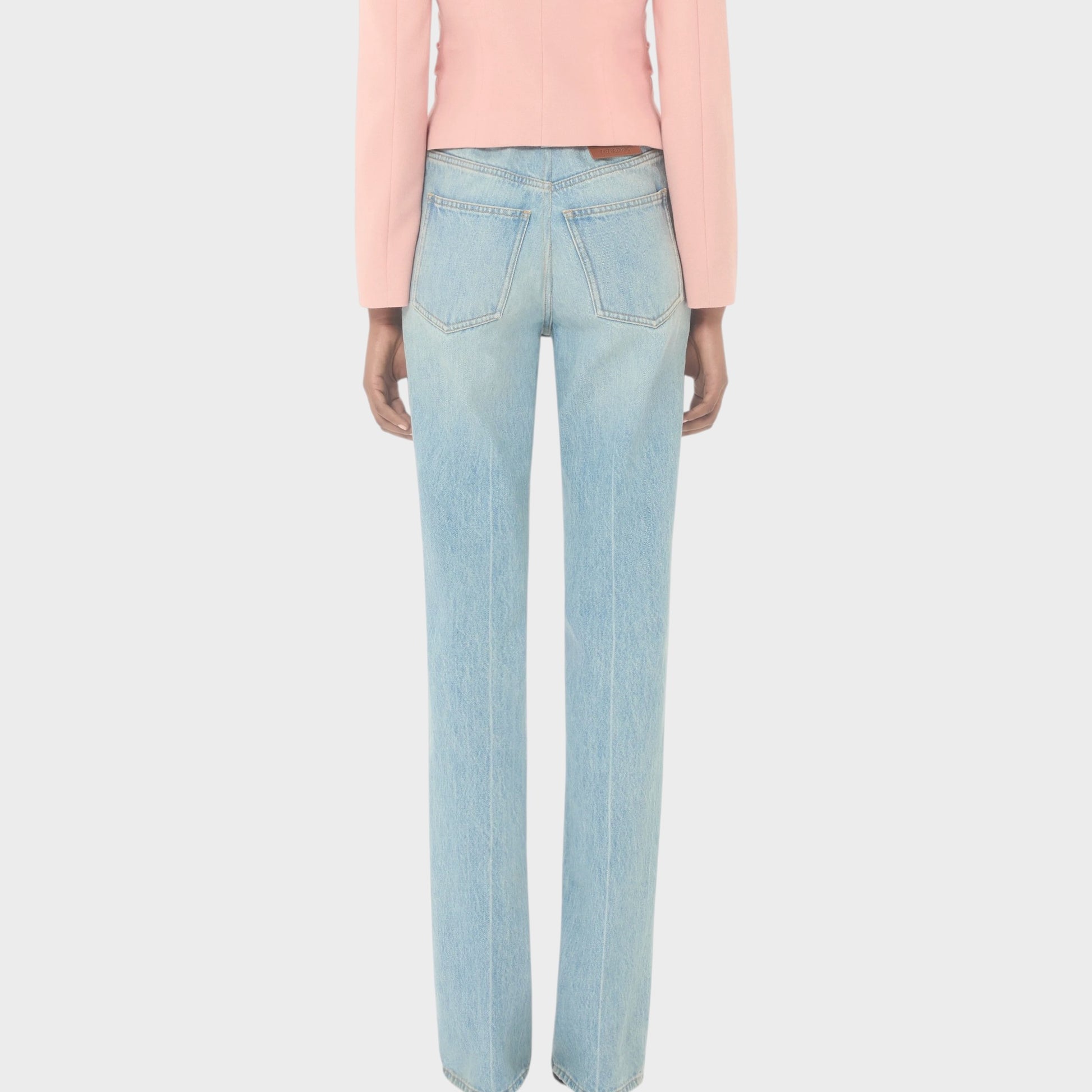 Tasoni Valentino high-waisted straight leg light wash denim jeans with a pink blazer.