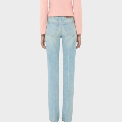 Tasoni Valentino high-waisted straight leg light wash denim jeans with a pink blazer.