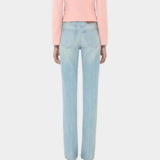 Tasoni Valentino high-waisted straight leg light wash denim jeans with a pink blazer.