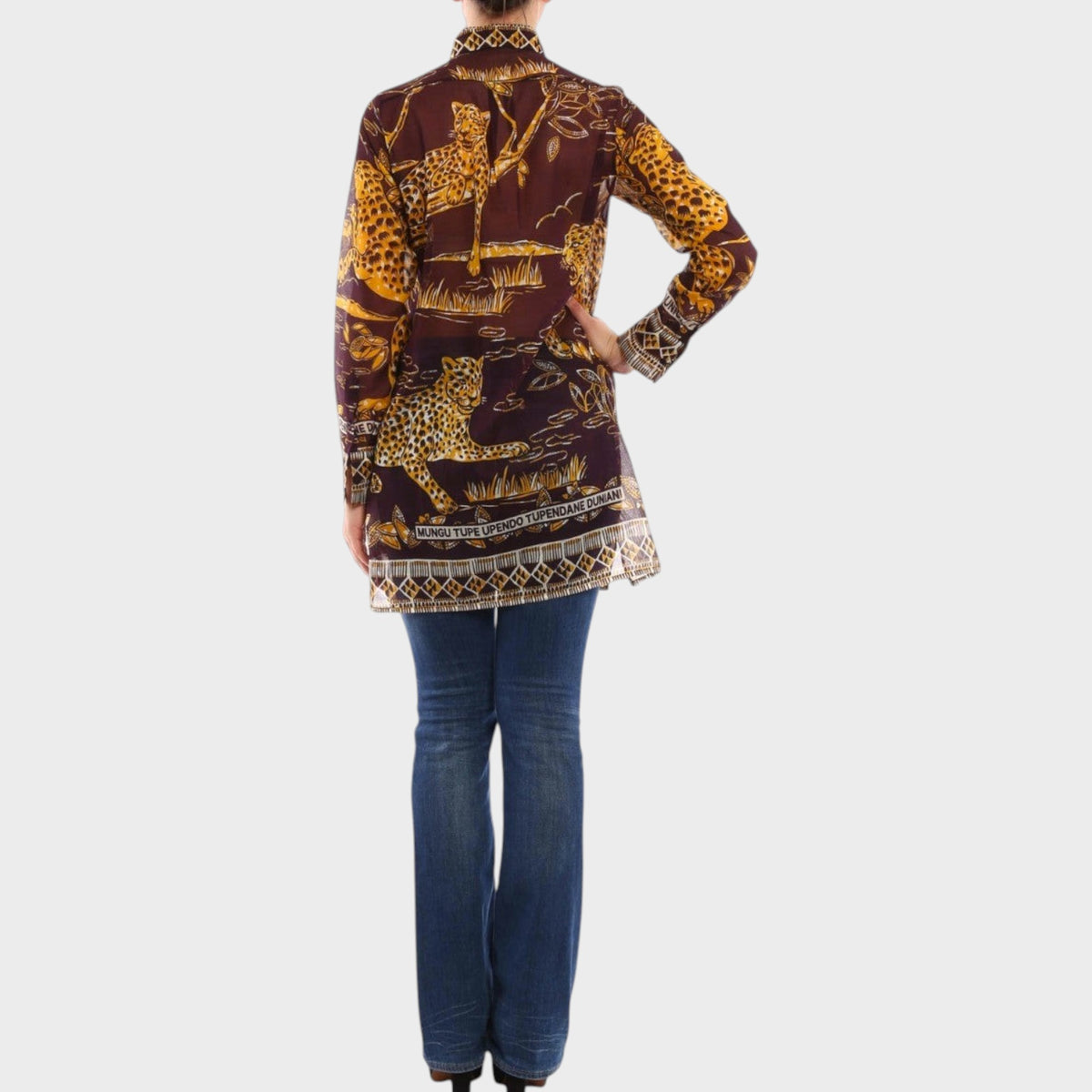 Tasoni Valentino long shirt featuring a brown and gold jaguar print, worn with blue jeans, back view