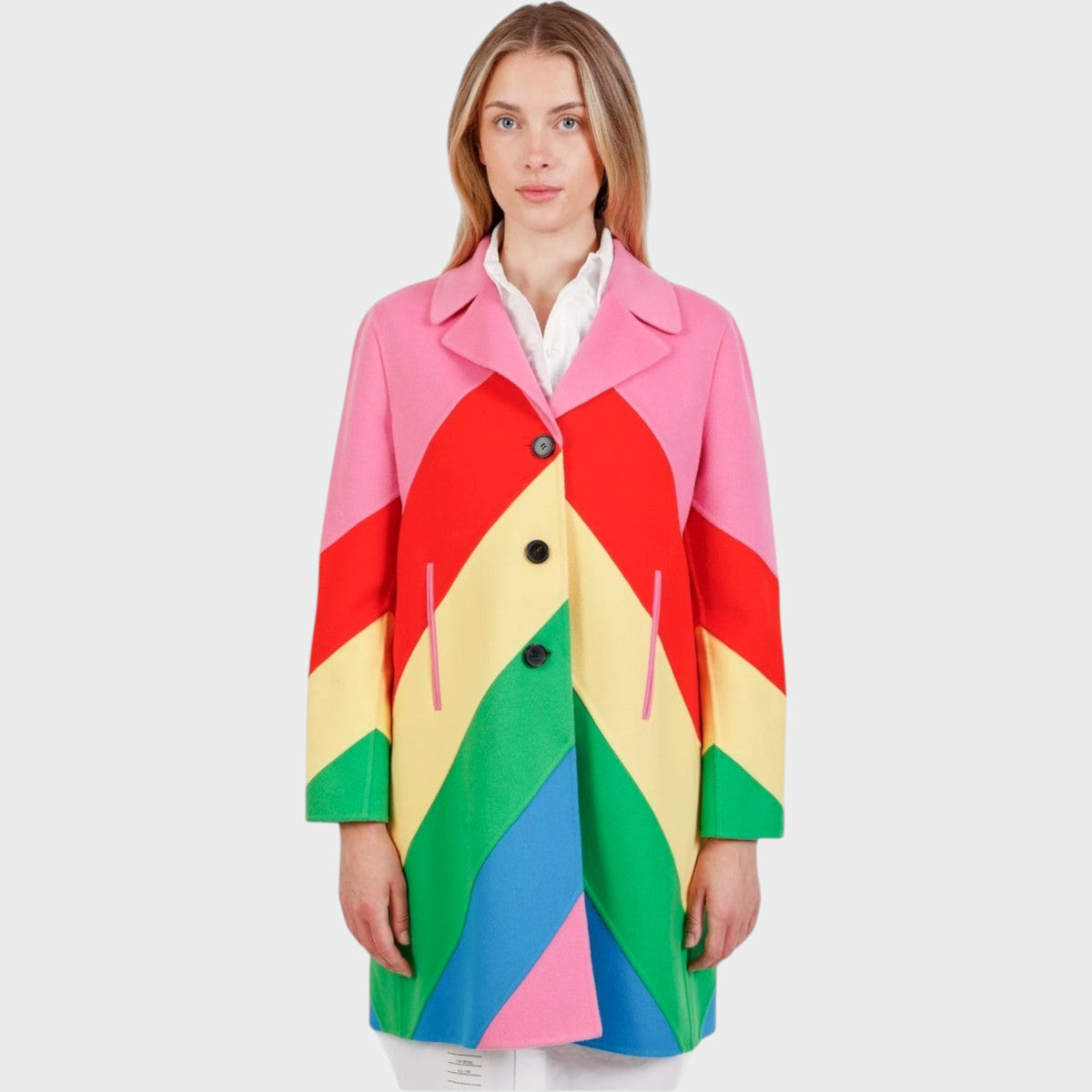 Tasoni Valentino rainbow coat featuring vibrant chevron stripes in pink, red, yellow, green, and blue on a model.