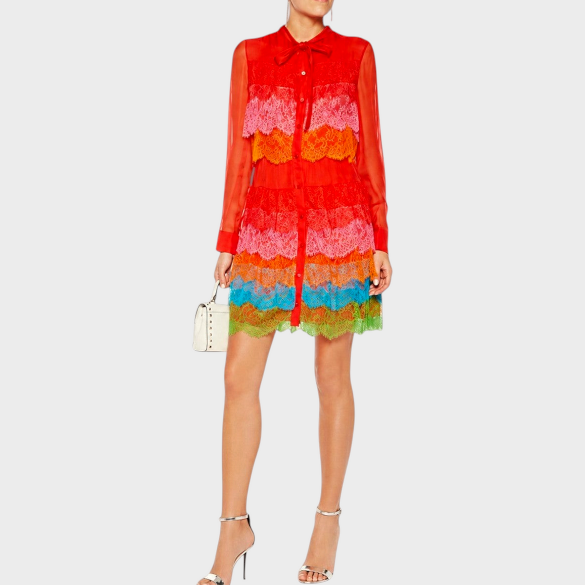 Tasoni Valentino lace layered rainbow dress with long sleeves and a bow-tie collar worn by a model.