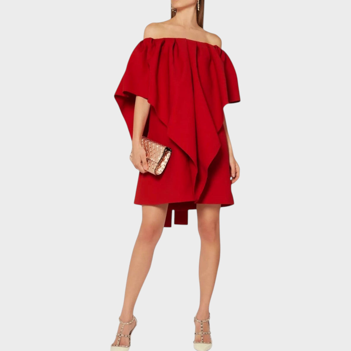 Tasoni Valentino red wool off-shoulder mini dress with draped ruffle detail worn by a model with a gold clutch