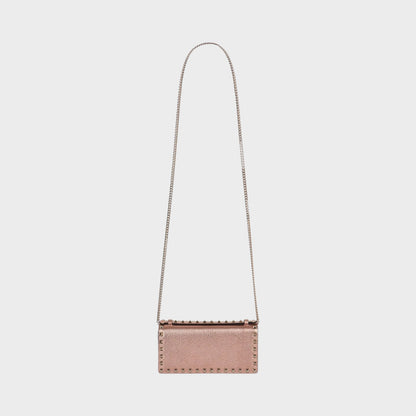 Tasoni Valentino Rockstud wallet in rose gold metallic leather with pyramid stud detailing and silver chain strap.