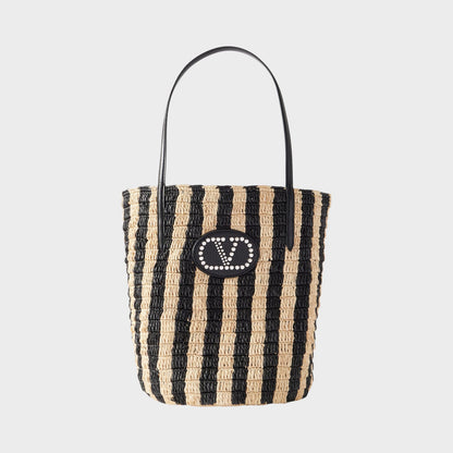 Tasoni Valentino V-Logo Crochet Raffia Bucket Bag with black and natural stripes and leather trim.