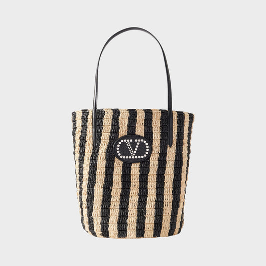 Tasoni Valentino V-Logo Crochet Raffia Bucket Bag with black and natural stripes and leather trim.