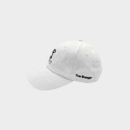 Tasoni white cotton baseball cap with bear embroidery and Tina Braegger signature.