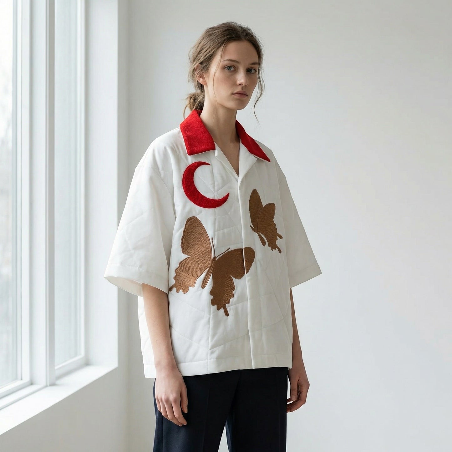Tasoni white oversized short sleeve shirt with red collar, featuring embroidered butterflies and a red moon graphic.