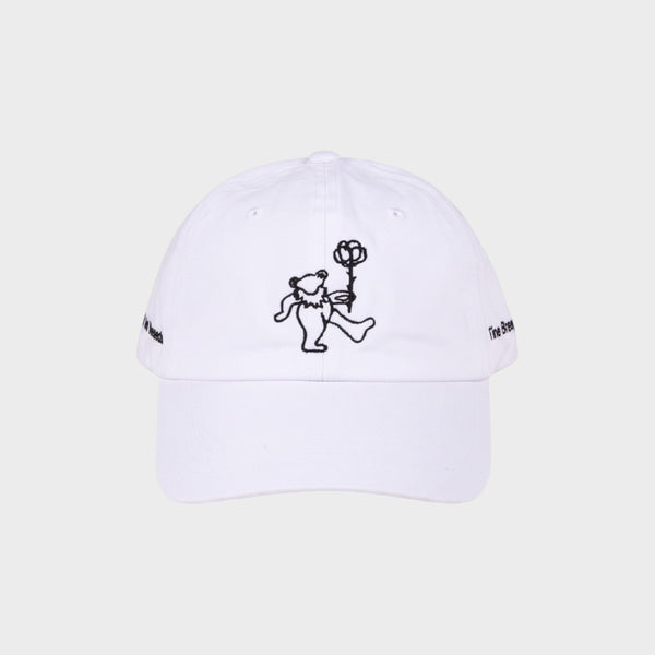Tasoni x Tina Braegger white baseball cap with embroidered dancing bear holding a rose and text on sides.