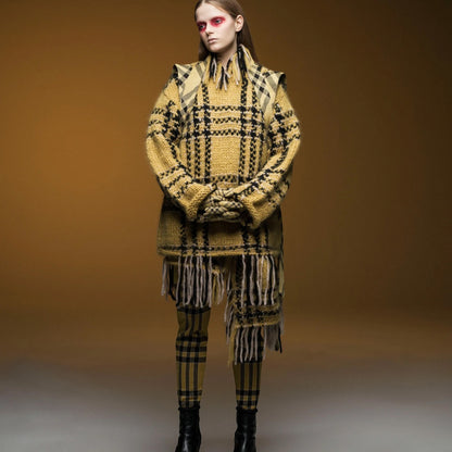 Tasoni yellow and black wool check elastic waist trousers with fringe detail and matching sweater. Model wears black boots.