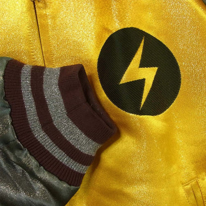 Tasoni yellow bomber jacket with lightning bolt graphic and striped cuffs.